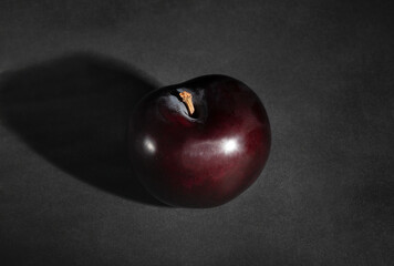 deep red burgundy plum on black background