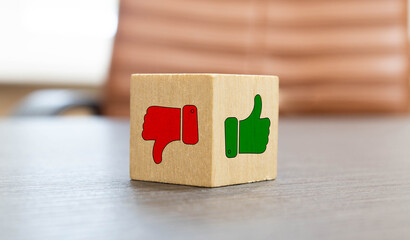 mock up miniature wooden blocks of thumbs up and thumbs down concept of like and dislike. © Uladzislau