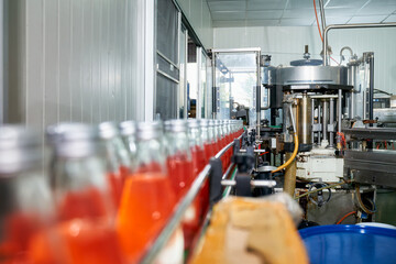 Inside of beverage industry automatic machine with product line of red juice