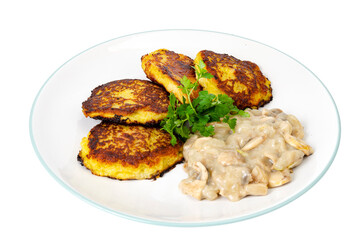 Fried grated potato pancakes with mushroom sauce. Studio Photo