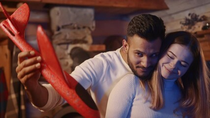 Happy multiracial couple hugging and playing with airplane toy. Young parents expecting baby. High quality 4k footage