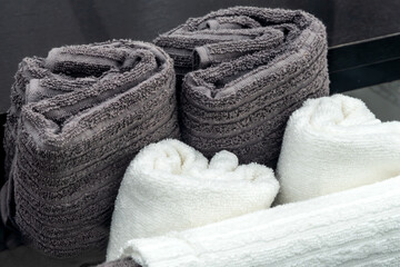 White and grey terry towels placed in a drawer