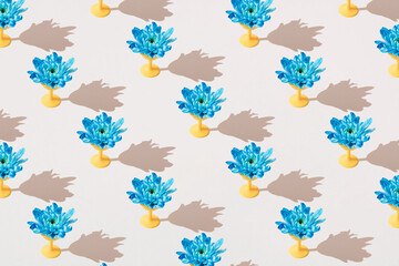 Fototapeta na wymiar Blue flower on a yellow plastic carrier. Minimal template.