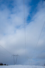 Fototapeta premium Electricity pylon under winter sky