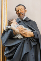 VIENNA, AUSTIRA - OCTOBER 22, 2020: The carved polychome sculpture of  St. Vincent de Paul in the...
