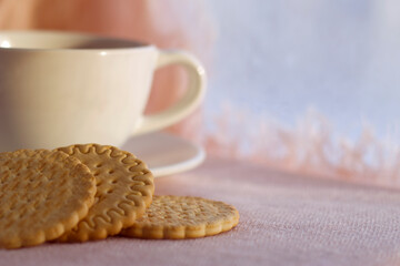 cup of tea and cookies near the window with snow view - still life, winter warm background