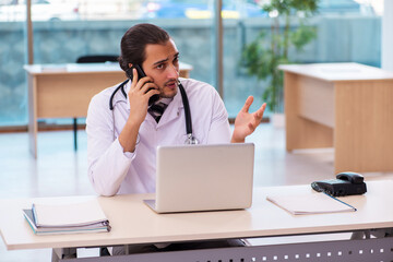 Young male doctor in telemedicine concept