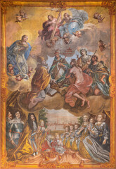 VIENNA, AUSTIRA - OCTOBER 22, 2020: Paint of adoration of Holy Trinity with the saints, lords and Vienna city in the background in church Rochuskirche by unknown artist.