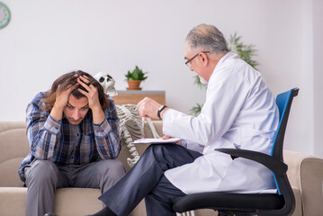 Young male patient visiting experienced doctor psychiatrist