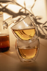 Double-bottom glasses are stacked on top of each other. Natural motives in warm colors. Breakfast glasses with tea.
