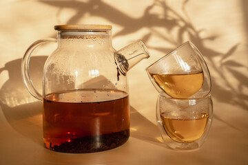 Double-bottom glasses are stacked on top of each other. Natural motives in warm colors. Breakfast glasses with tea.
