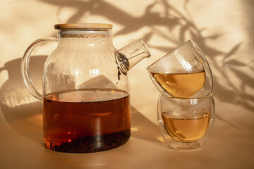 Double-bottom glasses are stacked on top of each other. Natural motives in warm colors. Breakfast glasses with tea.