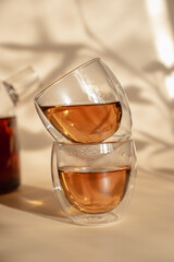 Double-bottom glasses are stacked on top of each other. Natural motives in warm colors. Breakfast glasses with tea.
