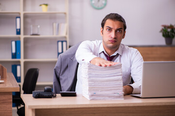 Young male employee extremely tired with excessive work