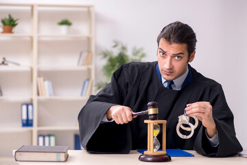 Young male judge in time management concept