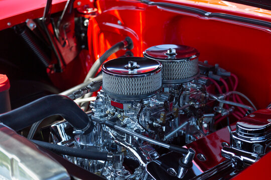 An Under the Hood Side View of Restored Vintage Automobile Engine with Twin Show-Chrome Air Filter