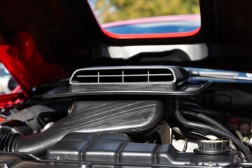 An Under the Hood Frontal View of a Restored Vintage Automobile Engine with Shaker Scoop Style Air Filter