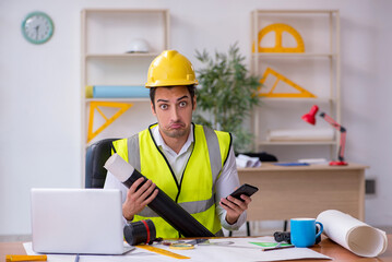 Young male architect working in the office