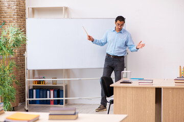 Young male teacher in the classroom