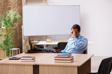 Young male teacher in the classroom