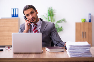 Young male employee working in the office