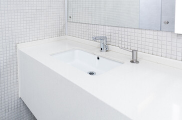Sink for people to wash their hands in a public toilet.