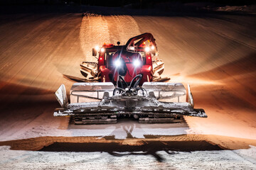 Snowcat ratrack machine making night snow at ski resort