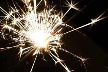 Bright sparks in total darkness. Closeup.