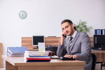 Young male employee working in the office