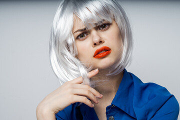 emotional woman in white wig red lips blue shirt cropped view open mouth