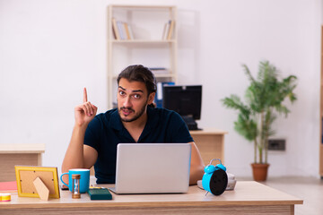 Young male employee working at workplace