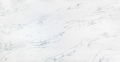 An off-white marble looking quartz slab with grey and navy blue veins that move in a wave-like direction