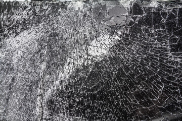 Severely broken smartphone screen, large cracks, close-up