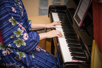 Playing the piano in a kimono
