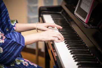 Playing the piano in a kimono
