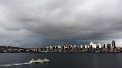 A ferry boat transports people and cars across the water of the Puget Sound towards the Washington...