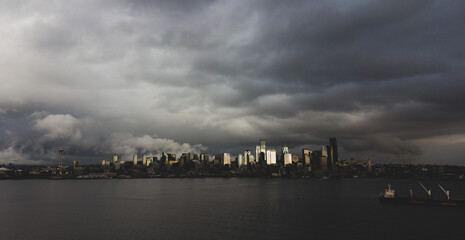 Fototapeta premium Dark clouds in the sky over the Puget Sound water and the city of Seattle in Washington state. 
