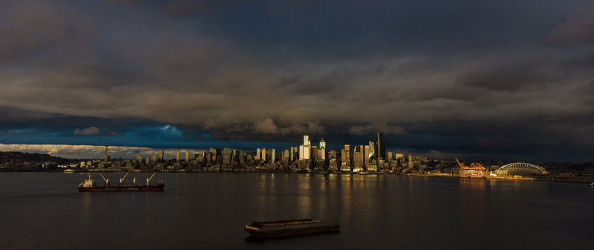 Panoramic view of the Seattle cityscape skyline behind the water of the Puget Sound in Washington State.
