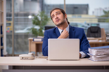 Young male employee working in the office