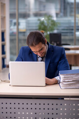 Young male employee working in the office