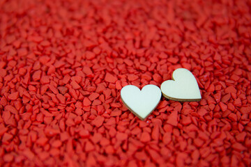 Close-up two hearts for love symbol on a red sand background. Concept the day of love 14 February happy valentine's day.