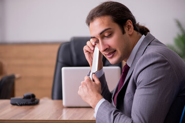 Young businessman employee in bullying concept in the office