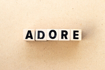Letter block in word adore on wood background