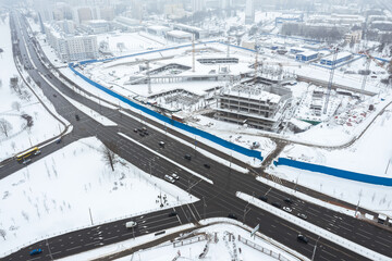 panoramic aerial view of big construction site in winter foggy day