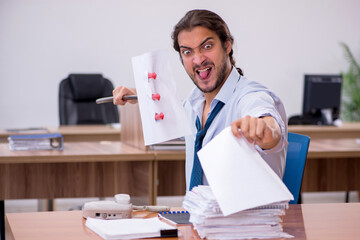Young devil businessman holding trident in the office