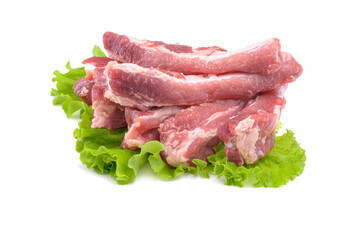 Raw pork ribs on a lettuce leaf are isolated on a white background.