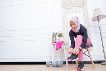 Young Asian muslim woman preparing for workout