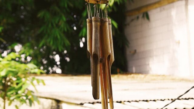Bamboo wind chimes in the teras of the house in the wind