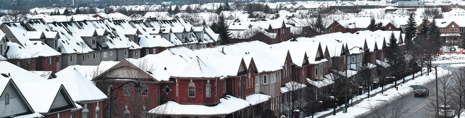 Rooftops of a small town during snowfall web banner