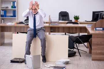 Old businessman employee in bankruptcy concept in the office